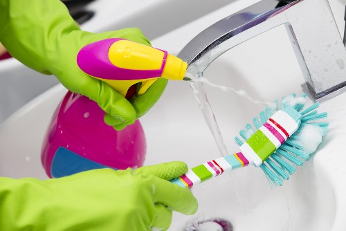 Local cleaner working in a SE10 apartment kitchen and dining area